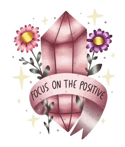 a pink crystal with flowers and a ribbon that says " focus on the positive "