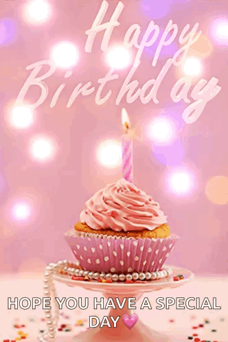 a pink cupcake with a pink frosting and a pink candle