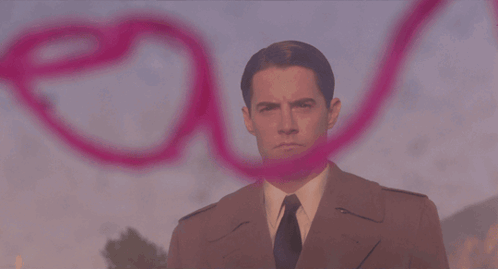 A Pink Heart Is Painted On A Wall With A Person Behind It GIF
