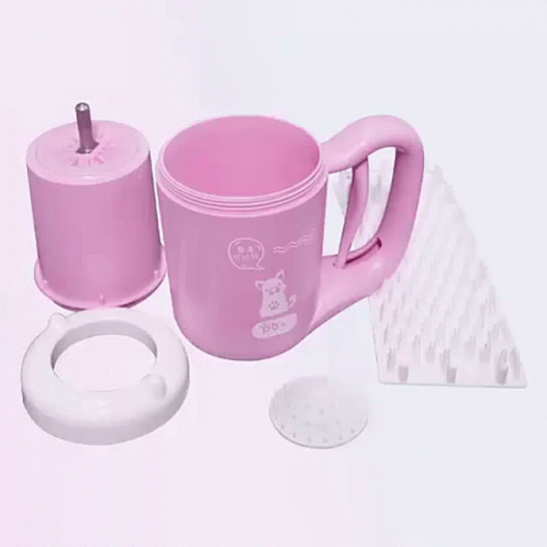 A Pink Mug With A Cat On It Is Being Disassembled On A Table . GIF