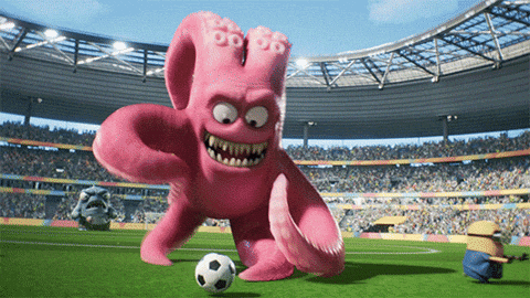A Pink Octopus Is Kicking A Soccer Ball On A Soccer Field GIF