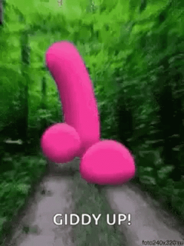 A Pink Penis Is Standing On A Dirt Road In The Woods . GIF