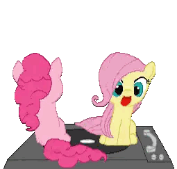 a pink pony and a yellow pony are sitting next to each other on a table