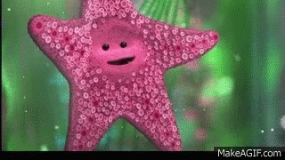 A Pink Starfish With A Face On It Is Swimming In The Water . GIF