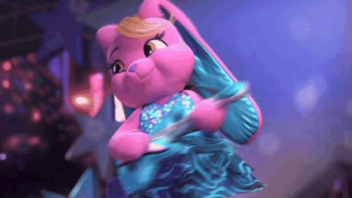 a pink stuffed animal in a blue dress is dancing on a stage