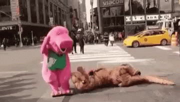 A Pink Stuffed Animal Is Standing Next To A Brown Stuffed Animal On A Street . GIF