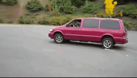 A Pink Van Is Driving Down A Road GIF
