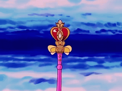 A Pink Wand With A Heart Shaped Top And A Crown On Top GIF