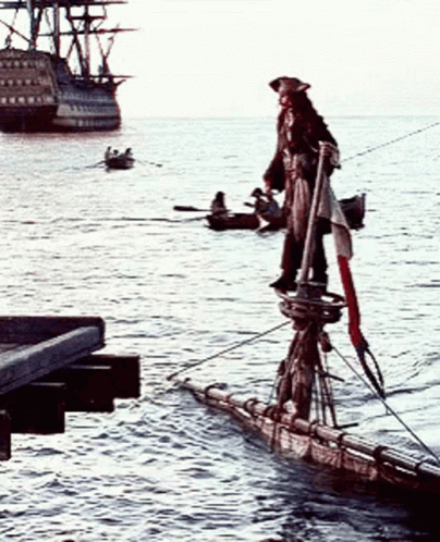 A Pirate Is Standing On A Boat In The Water GIF