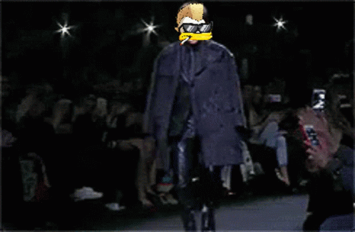 A Pixel Art Of A Man Walking Down A Runway Wearing Sunglasses And A Cigarette GIF