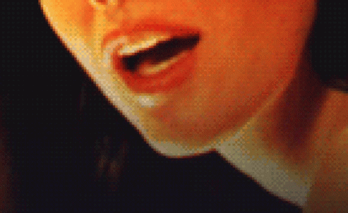 A Pixelated Close Up Of A Woman 'S Mouth With Her Tongue Out GIF