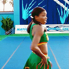 A Pixelated Image Of A Cheerleader In Front Of A Sign That Says Nation GIF