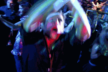 A Pixelated Image Of A Crowd Of People Dancing In A Dark Room GIF