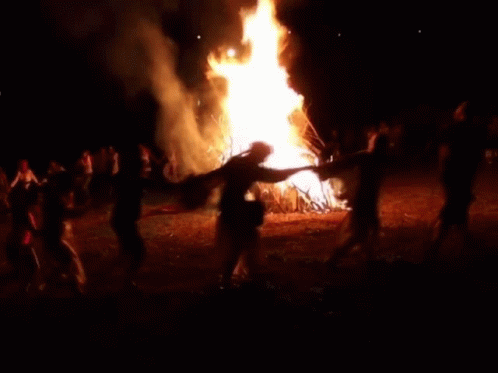 A Pixelated Image Of A Man Dancing In Front Of A Fire GIF