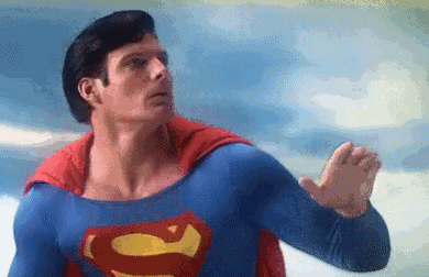 A Pixelated Image Of A Man In A Superman Costume Flying In The Sky . GIF