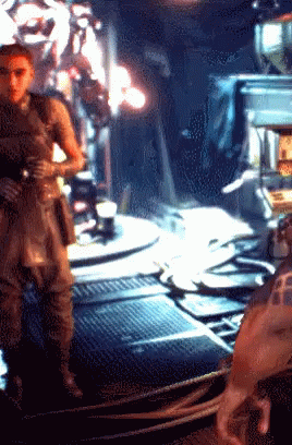 A Pixelated Image Of A Man Standing In A Room With The Letter F On His Arm GIF