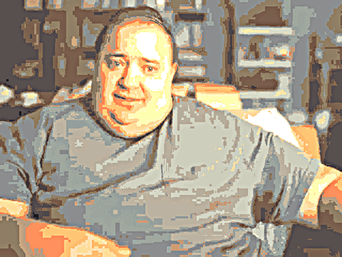A Pixelated Image Of A Man Wearing A Grey Shirt With A Star On The Front GIF