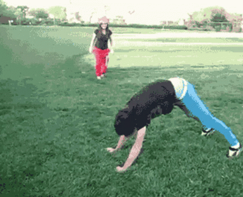 A Pixelated Image Of A Person Doing A Handstand In A Park GIF