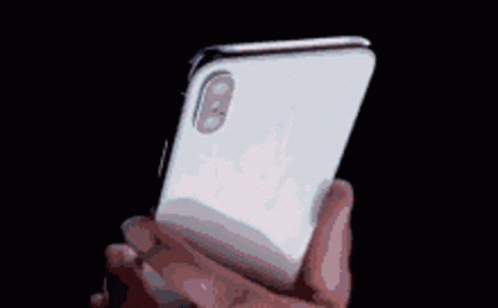 A Pixelated Image Of A Person Holding A White Iphone GIF