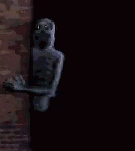 A Pixelated Image Of A Skeleton Peeking Out Of A Doorway . GIF