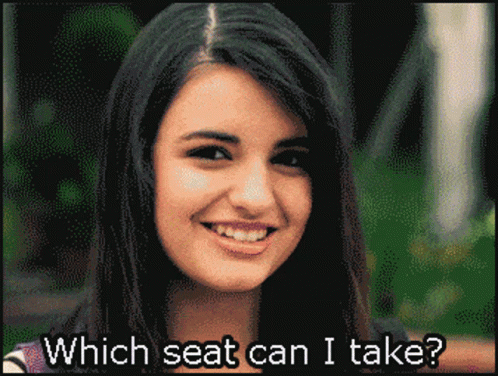 A Pixelated Image Of A Smiling Woman With The Words Which Seat Can I Take Below Her GIF