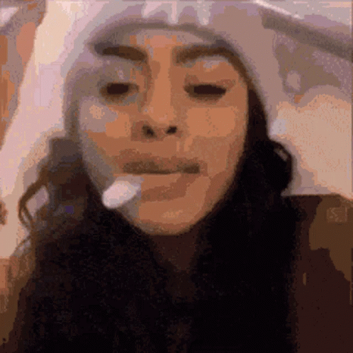 A Pixelated Image Of A Woman Wearing A Hat GIF