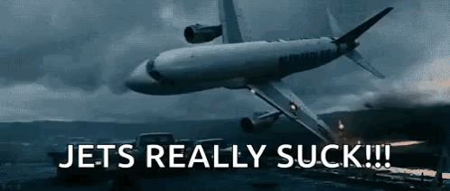 A Plane Is Flying Over A Field With The Words Jets Really Suck Below It GIF