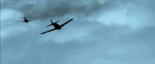 A Plane Is Flying Through A Blue Sky With A Few Clouds GIF