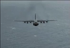 A Plane Is Flying Through The Air With Fire Coming Out Of The Wings GIF
