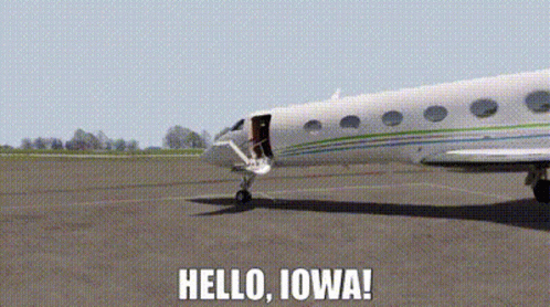 a plane is sitting on a runway with the words hello iowa written below it