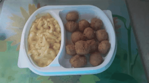 A Plastic Container Of Macaroni And Cheese And Fried Chicken Balls GIF