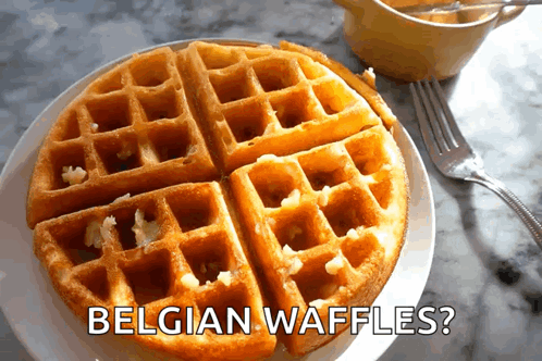 a plate of belgian waffles with a fork on a table
