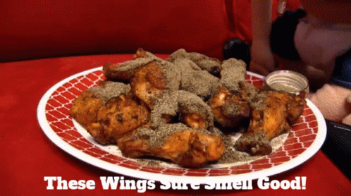 A Plate Of Chicken Wings With The Words " These Wings Sure Smell Good " On The Bottom GIF