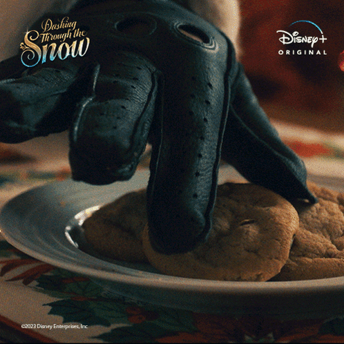 A Plate Of Cookies With The Words Dashing Through The Snow On The Top GIF