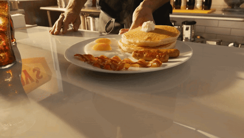A Plate Of Food With A Sign That Says A2 In The Background GIF