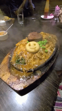 A Plate Of Noodles With A Smiley Face On Top GIF