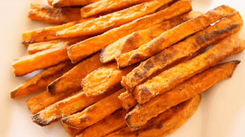A Plate Of Sweet Potato Fries On A White Surface GIF