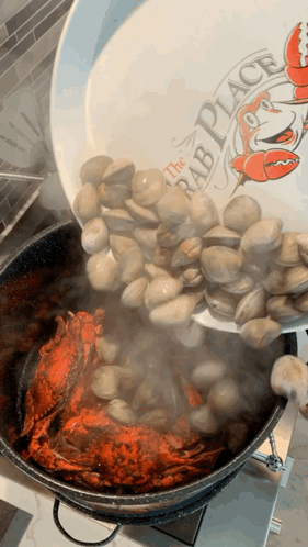 A Plate That Says The Crab Place Is Being Poured Into A Pot Of Clams GIF