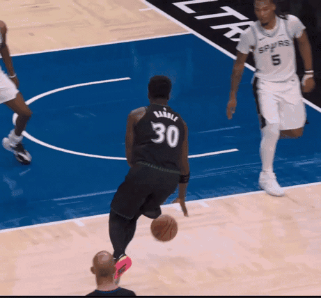 A Player With The Number 30 On Their Jersey Is Dribbling A Basketball GIF