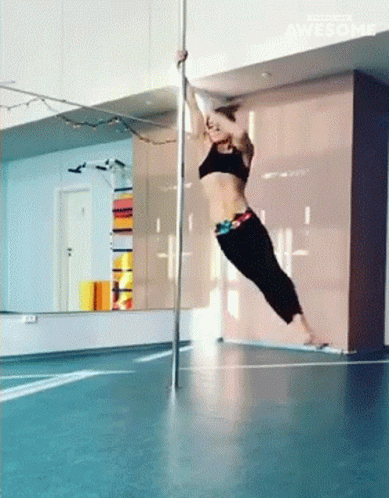 A Pole Dancer Is Doing A Trick In Front Of A Mirror And The Word Awesome Is On The Bottom Of The Screen GIF