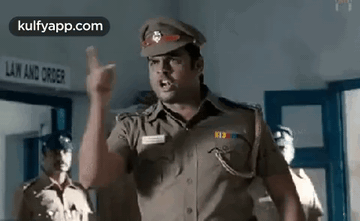 A Police Officer Is Giving A Speech In A Police Station . GIF