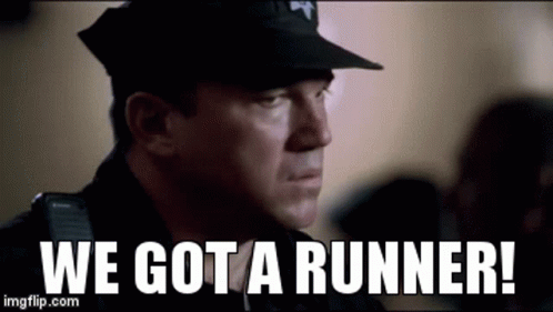 A Police Officer Is Standing In Front Of A Crowd And Says `` We Got A Runner ! '' GIF