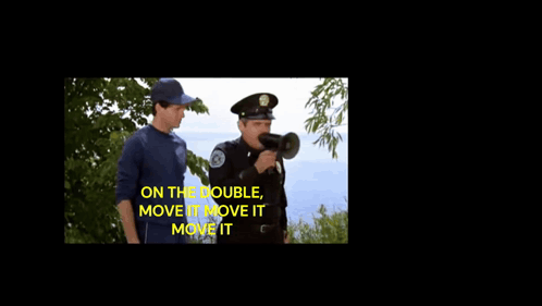 A Police Officer Shouting Into A Megaphone With The Words " On The Double Move It Move It Move It " GIF