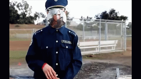 A Police Officer Wearing A Mask And Glasses GIF