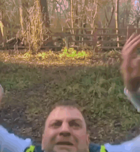 A Police Officer Wearing A Yellow Vest And Tie Is Yawning . GIF