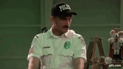 Police Officer Sitting At Desk GIF