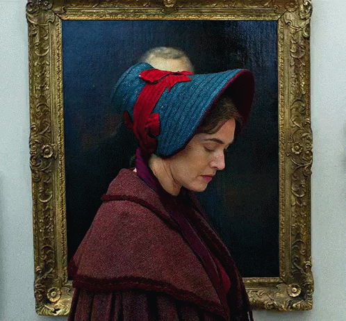 A Portrait Of A Woman Wearing A Blue Hat GIF