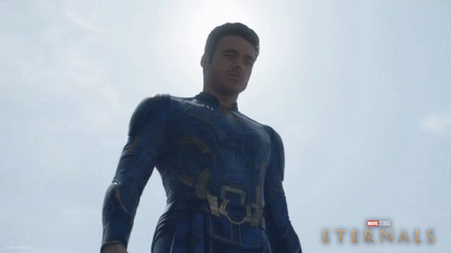 A Poster For A Movie Called Eternals With A Man In A Suit GIF