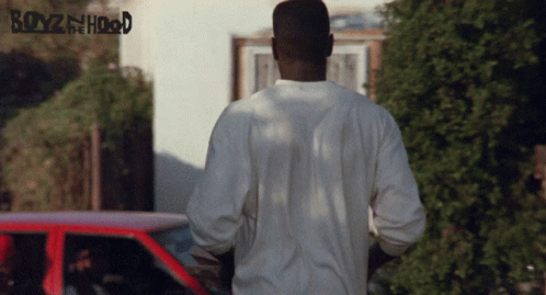 A Poster For Boyz In The Hood Shows A Man Standing In Front Of A Car GIF
