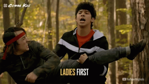 A Poster For Cobra Kai Shows A Man Carrying Another Man On His Shoulders GIF